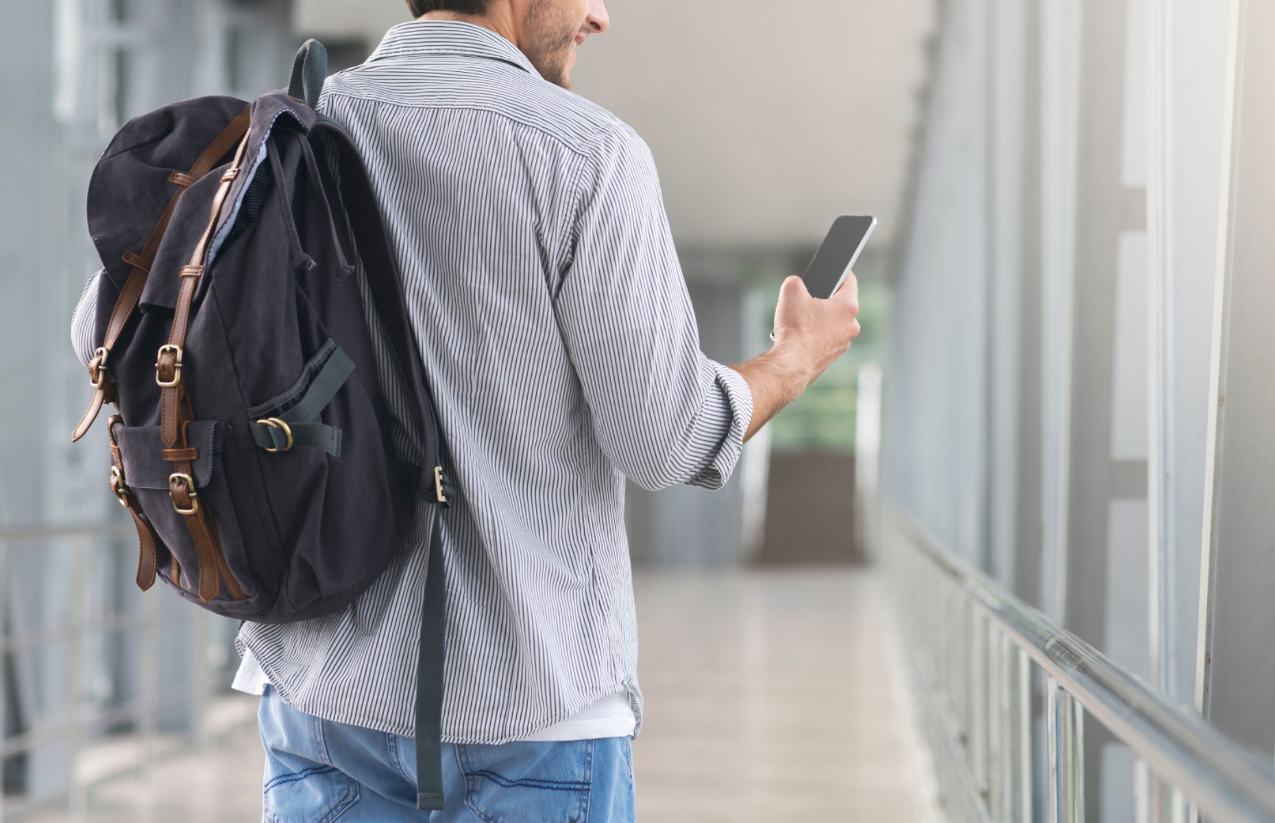 Man with backpack at airport (Image: Prostock-studio/Shutterstock)