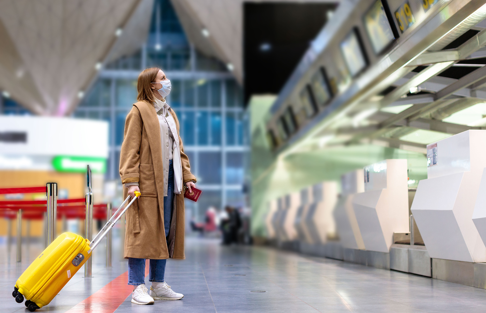 Passenger checks departure board at airport. (Image: DimaBerlin/Shutterstock)