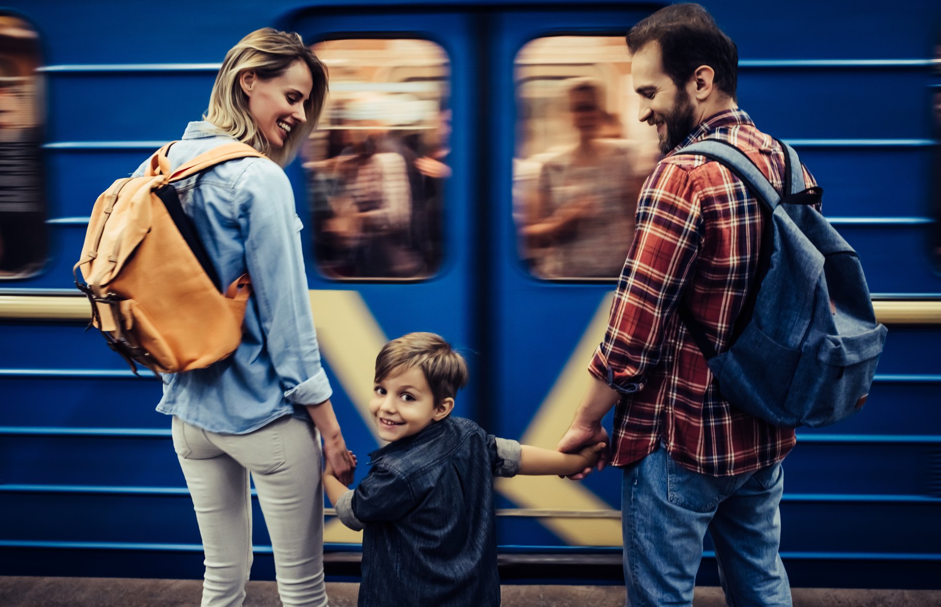 Family of three boarding a train together (Image: 4 PM production/Shutterstock)