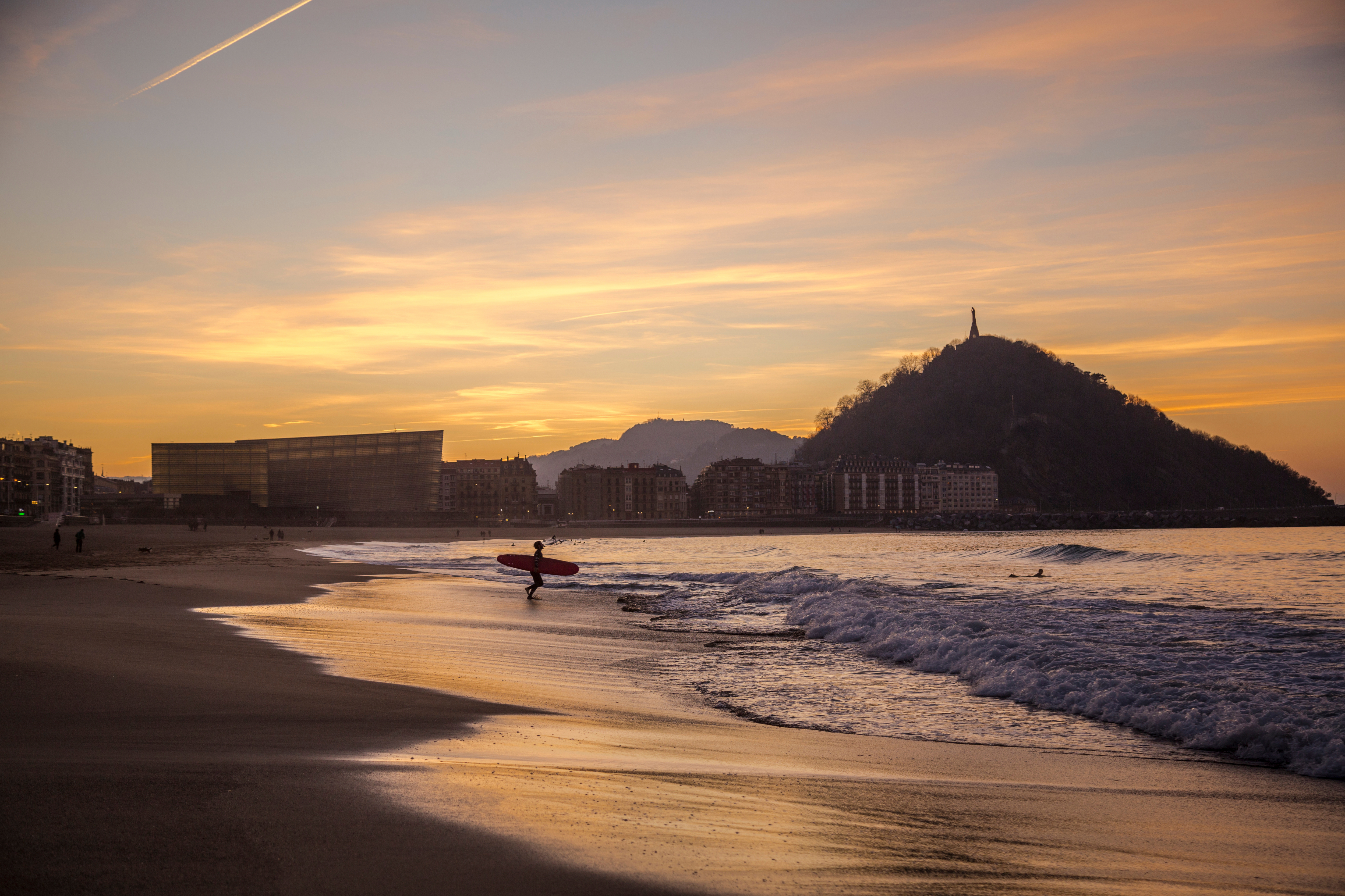 Surfer on beach at San Sebastian (Image: Unai Huizi Photography/Shutterstock)
