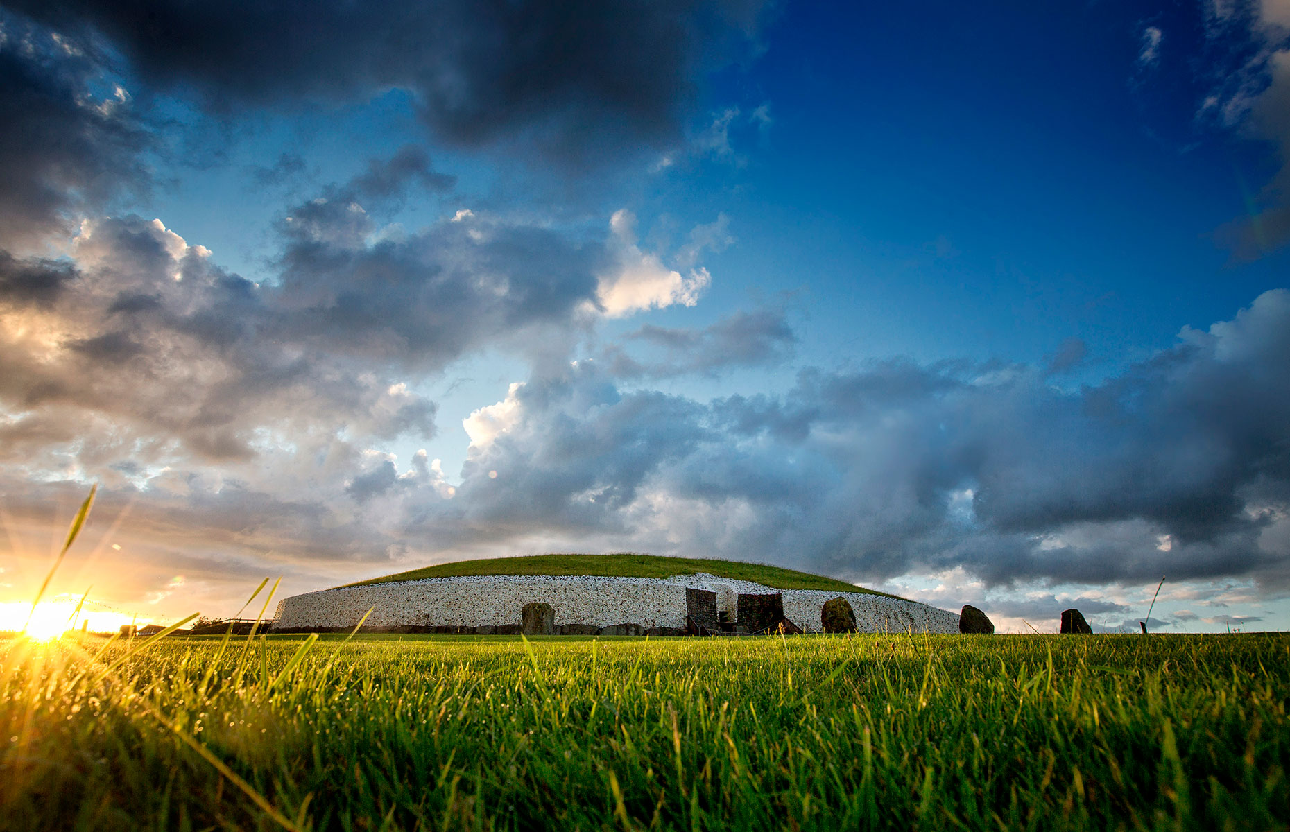 Newgrange monument is a tomb in the Boyne Valley, Ireland, pictured here at sunset