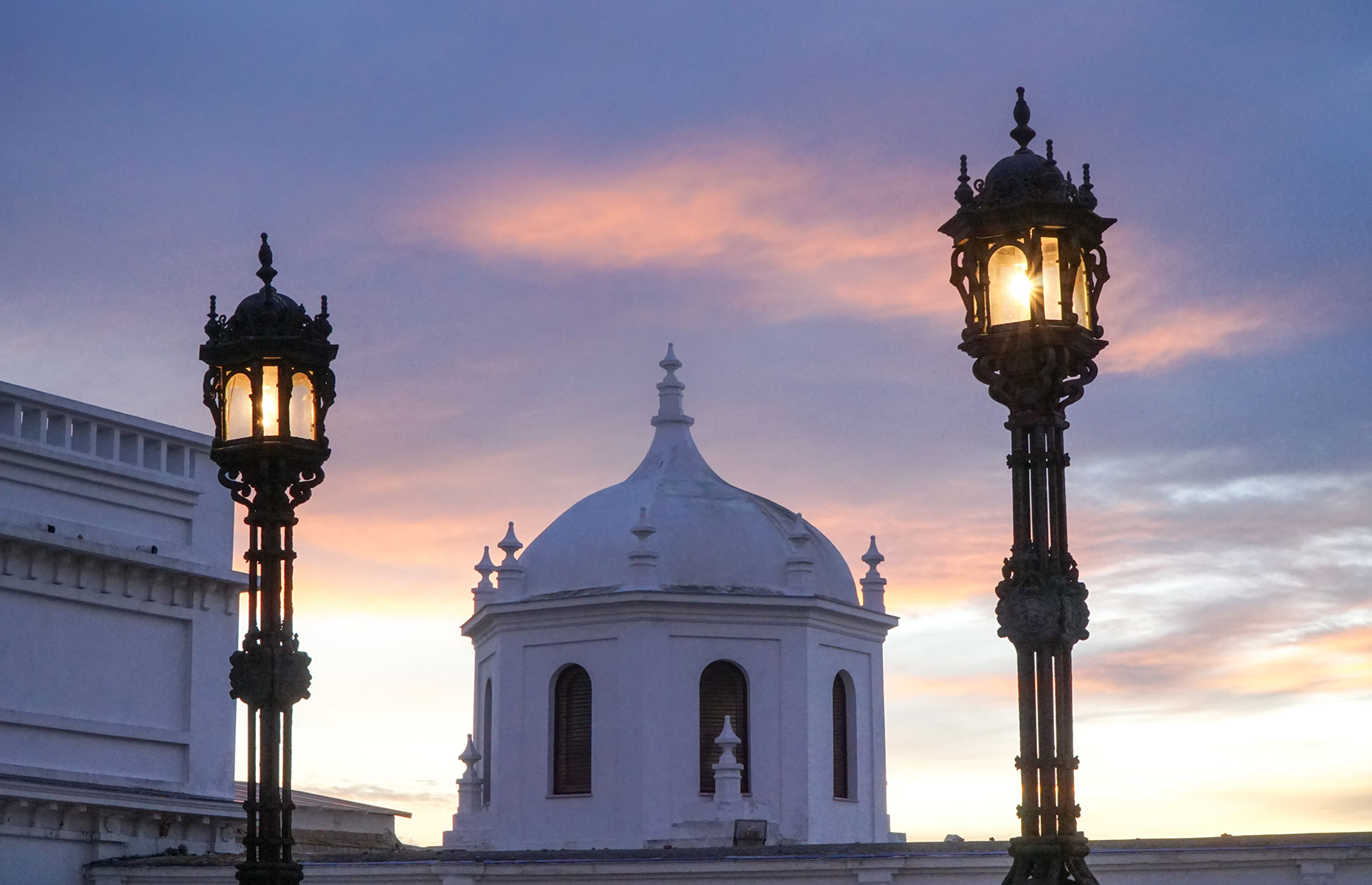 Dome building in Cadiz, Spain with sunset skyline