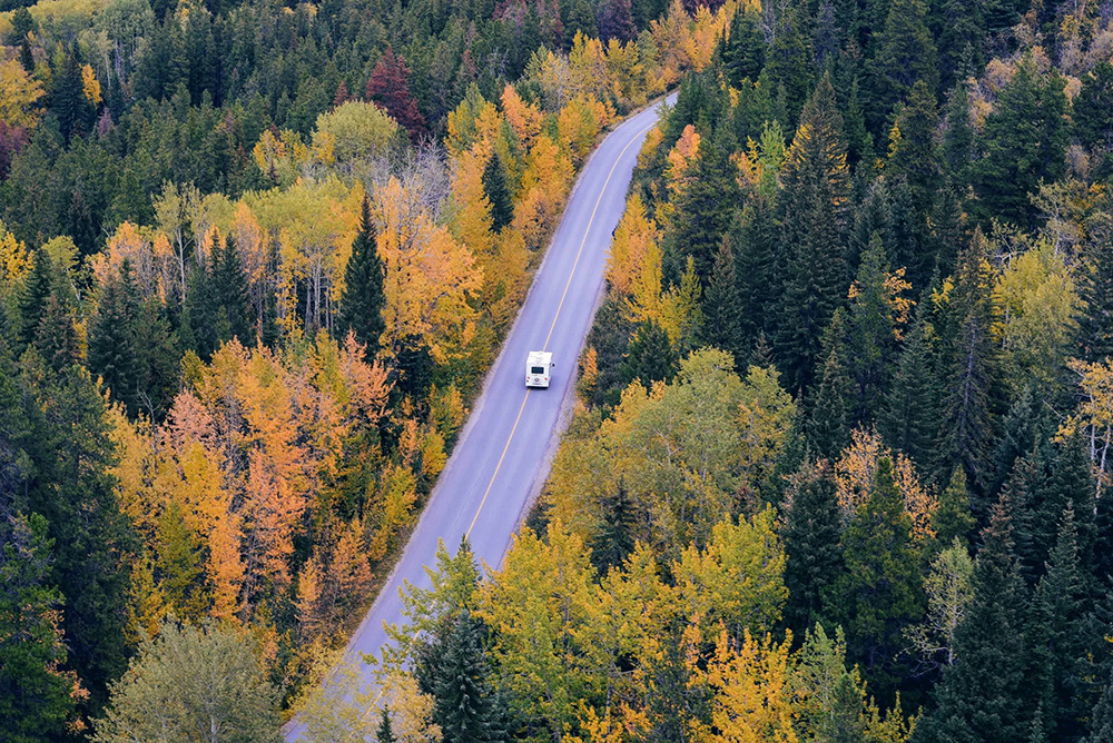 Motorhome driving through fall foliage