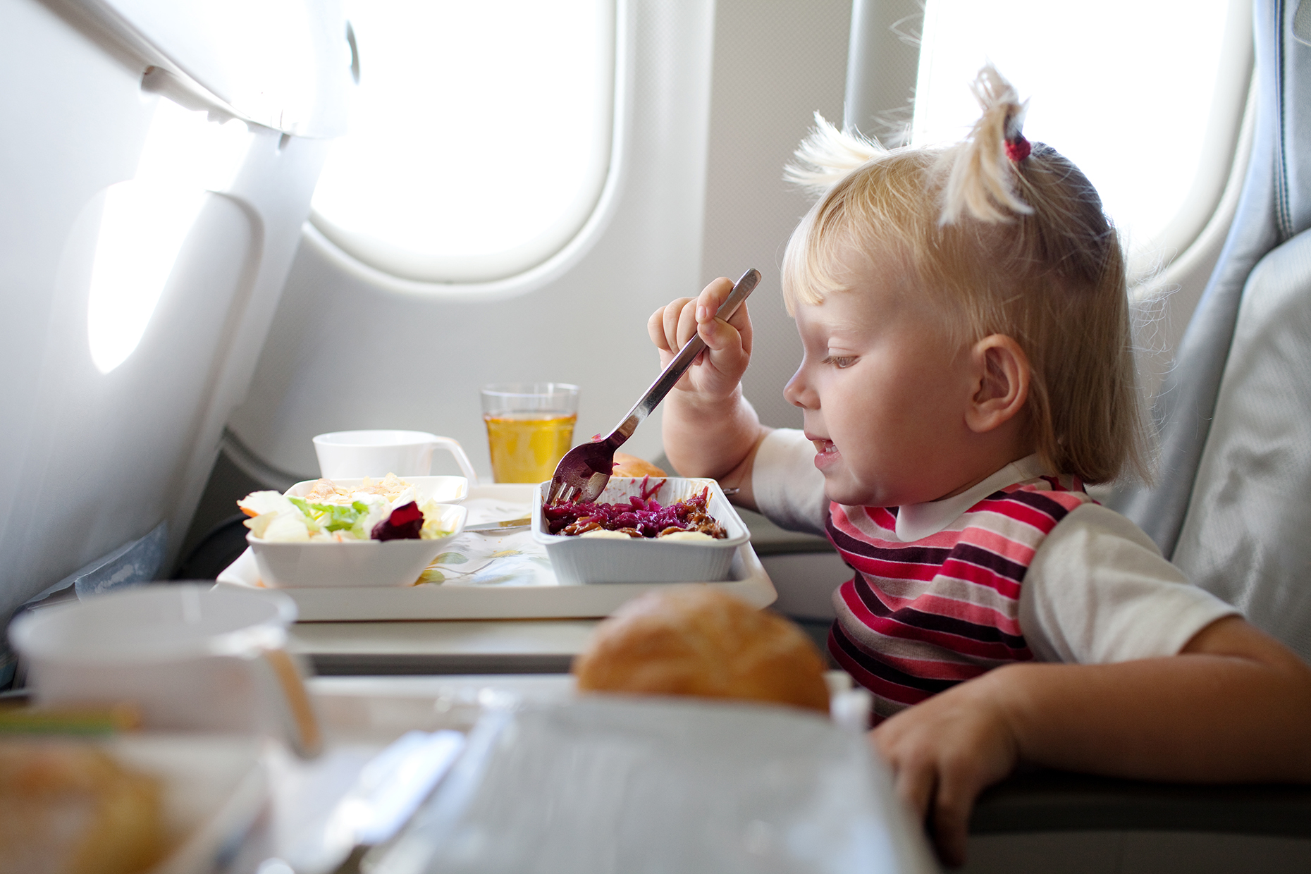 Baby eating plane food