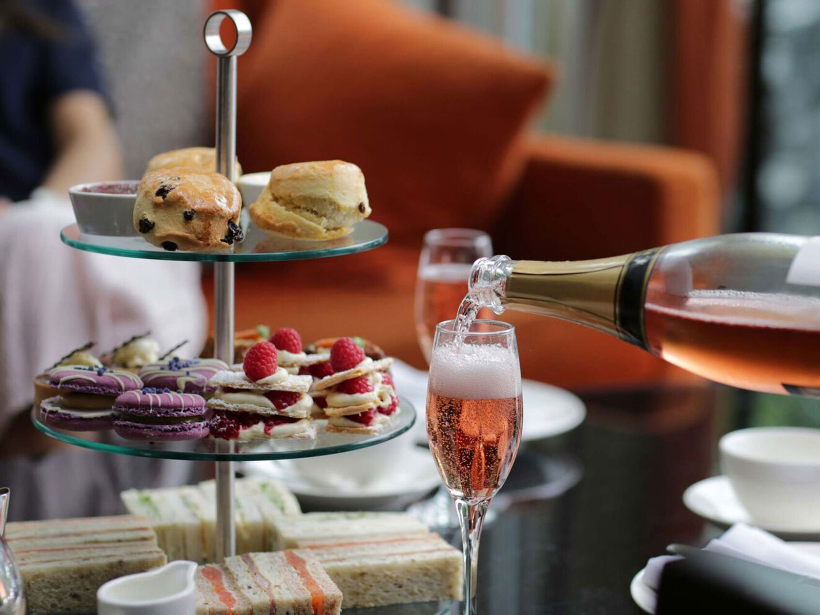 Traditional afternoon tea with glass of pink fizz