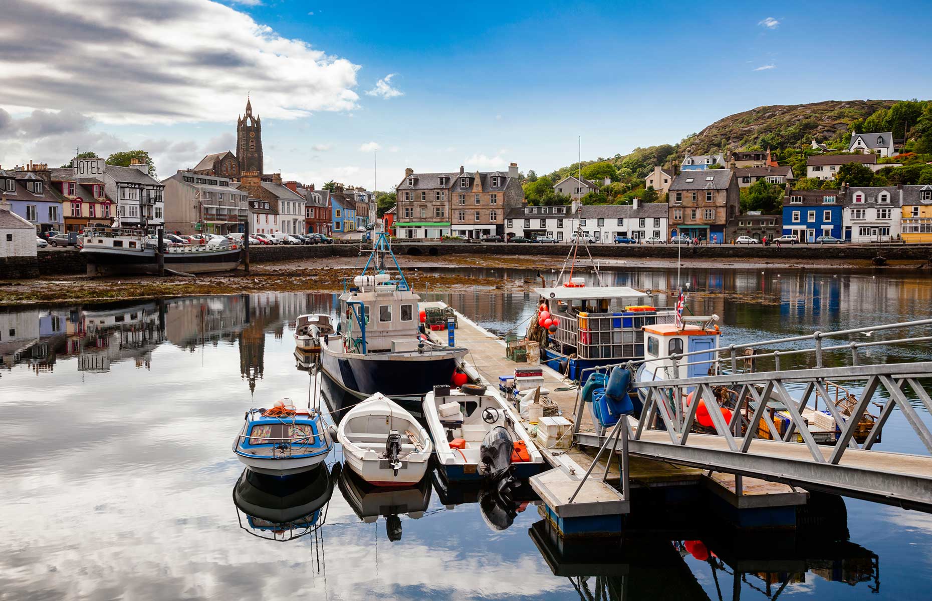 Tarbet village Scotland on a sunny day with boats in the foreground (Image: Dmitry Naumov/Shutterstock)