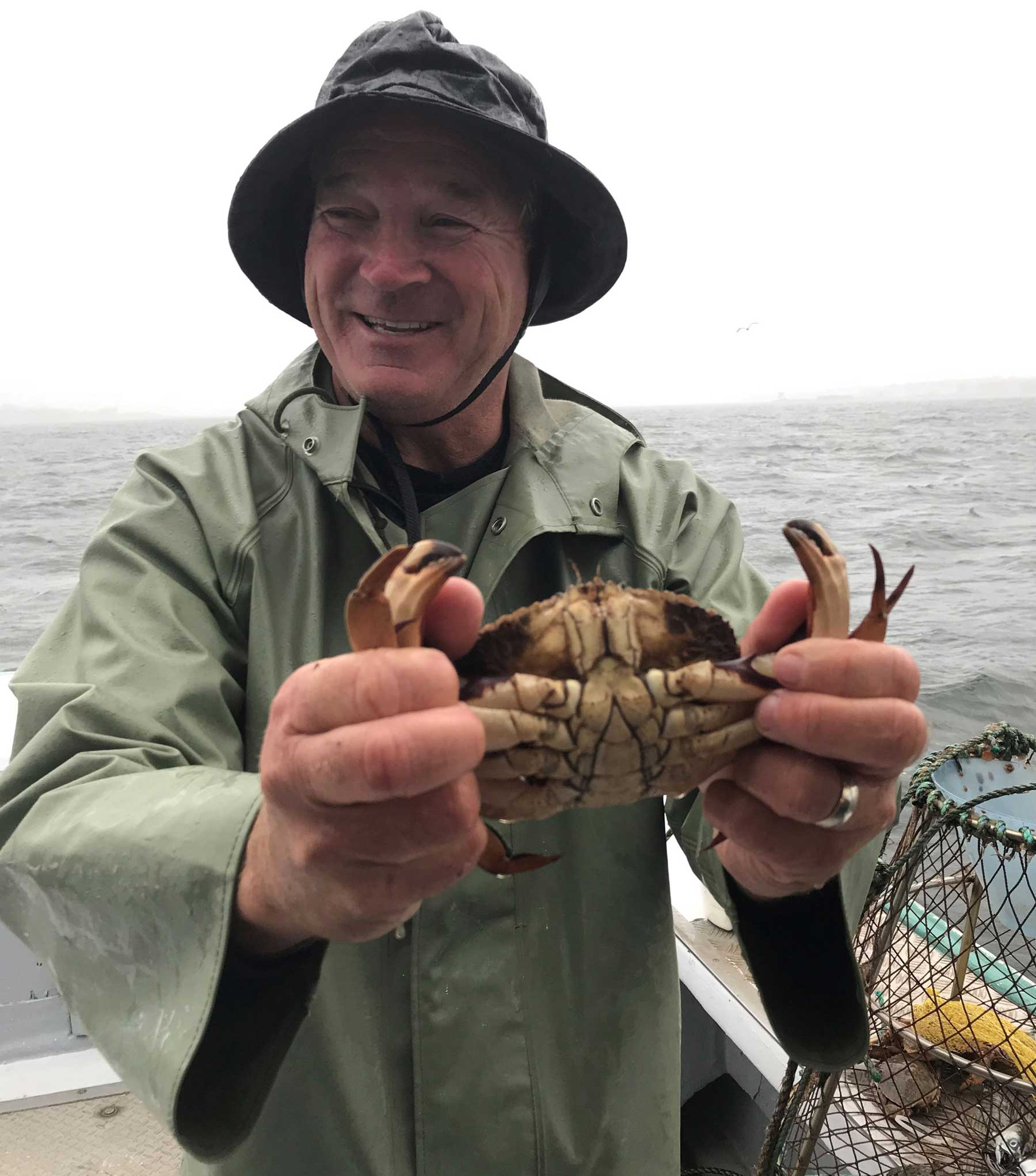 Perry Gotell with a crab, onboard his fishing boat Tranquillity 2000 off the coast of Georgetown, Prince Edward Island. 