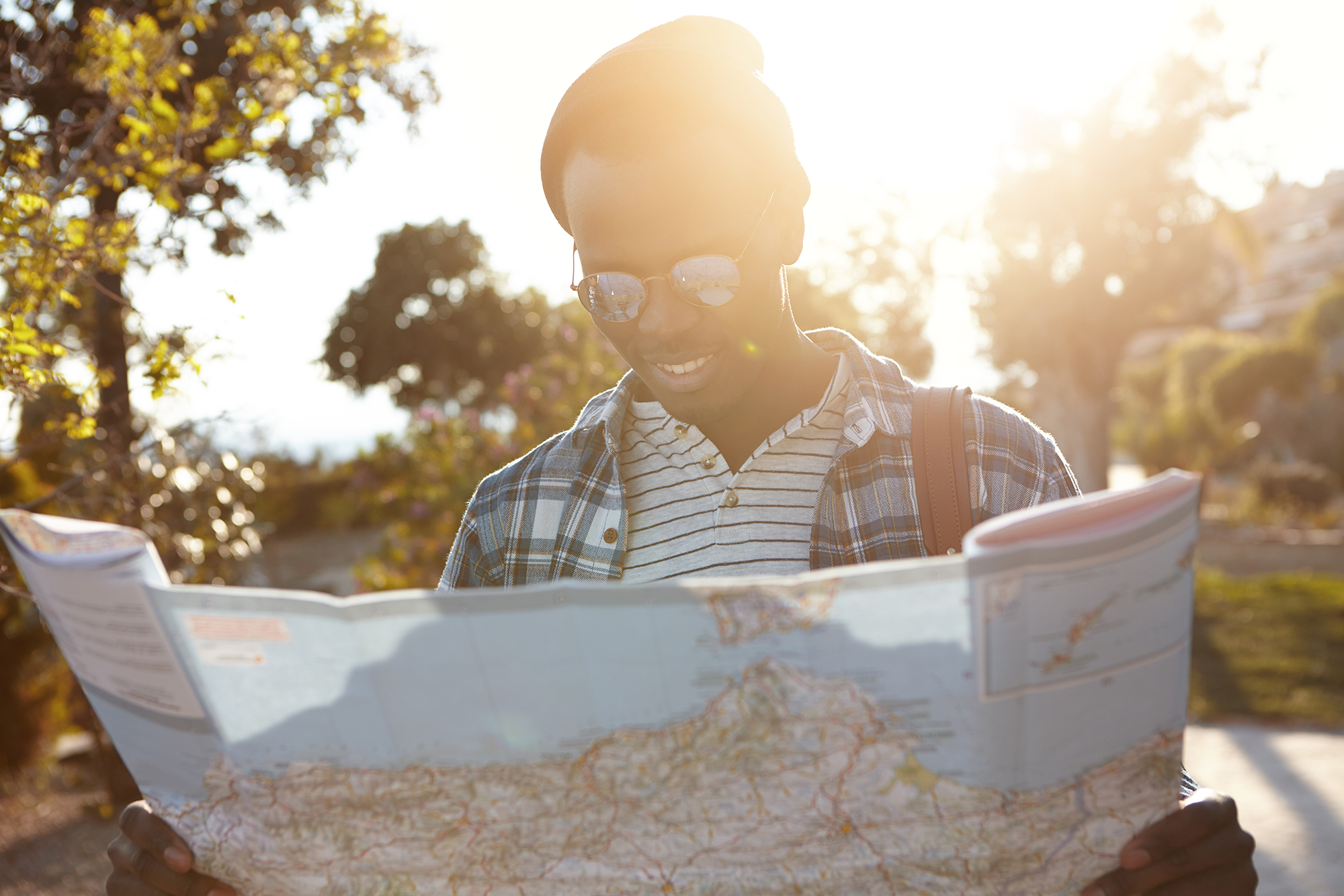 Man reading map travelling alone