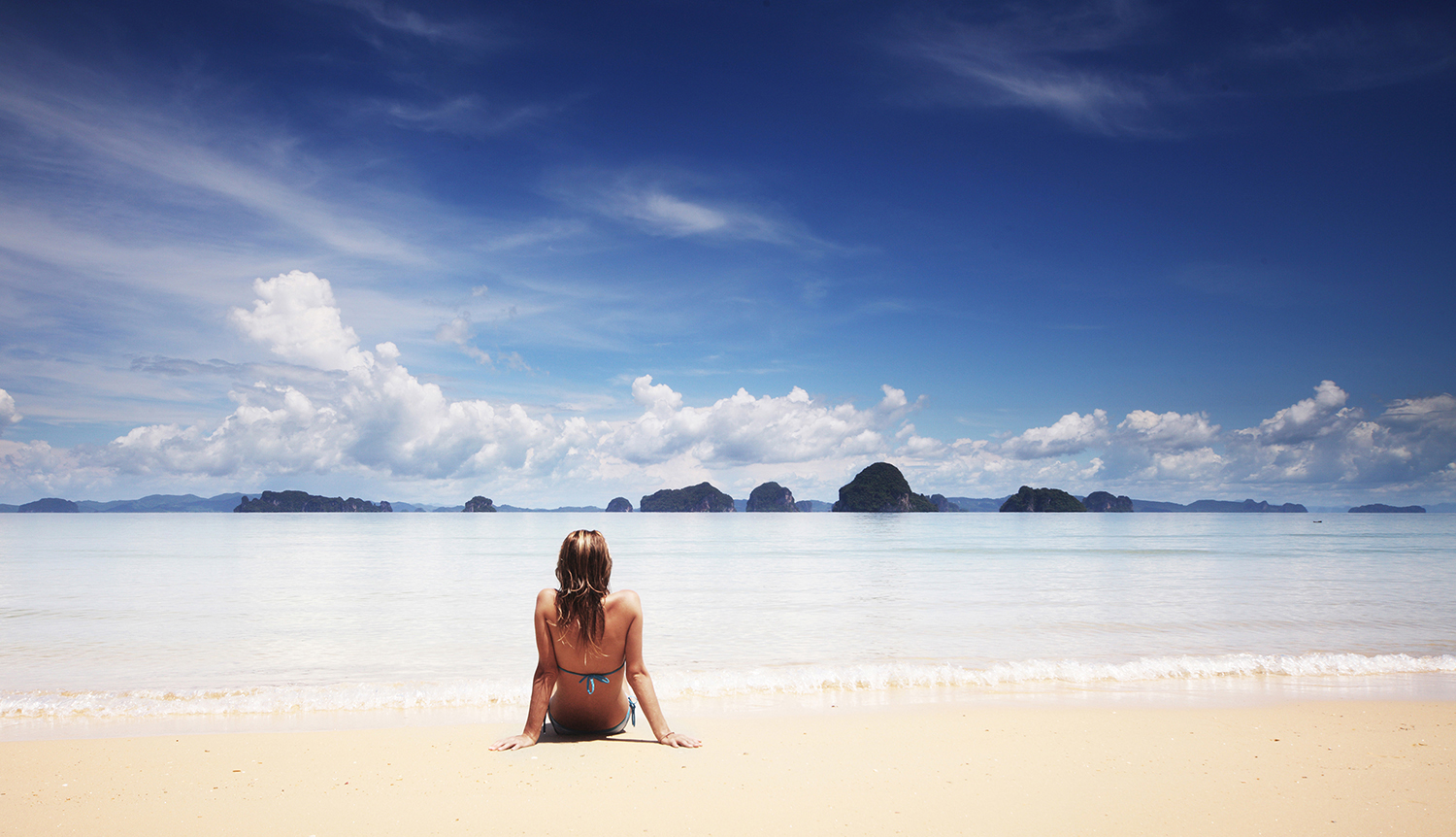 Woman on beach having digital detox holidays