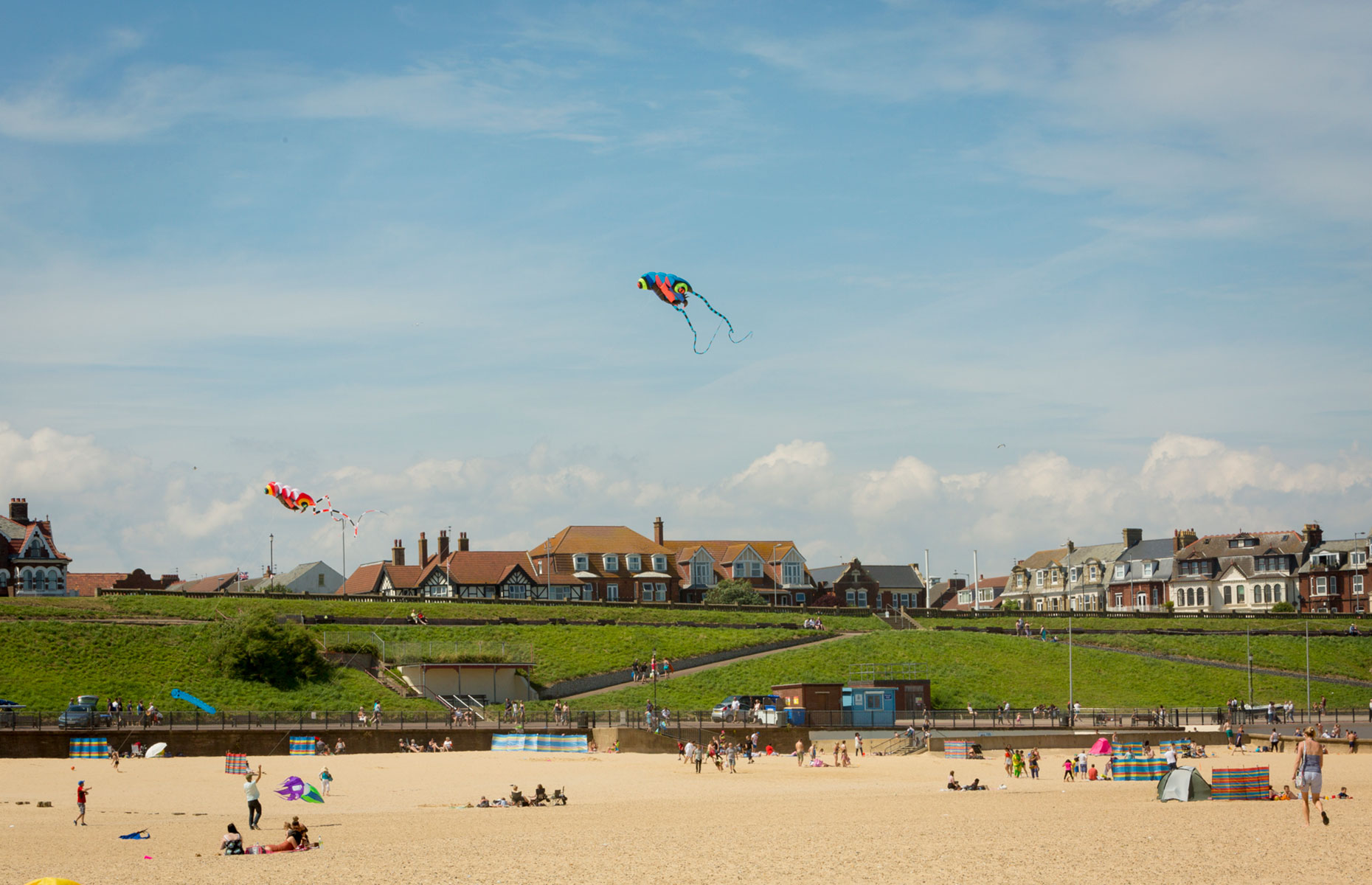 Gorleston-on-Sea's golden sandy beach on a sunny day with kites and sunbathers (Image: Visit Great Yarmouth)