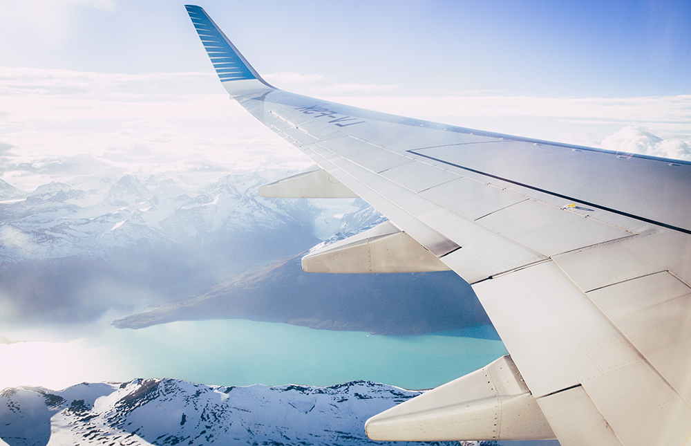 Plane flying over lake