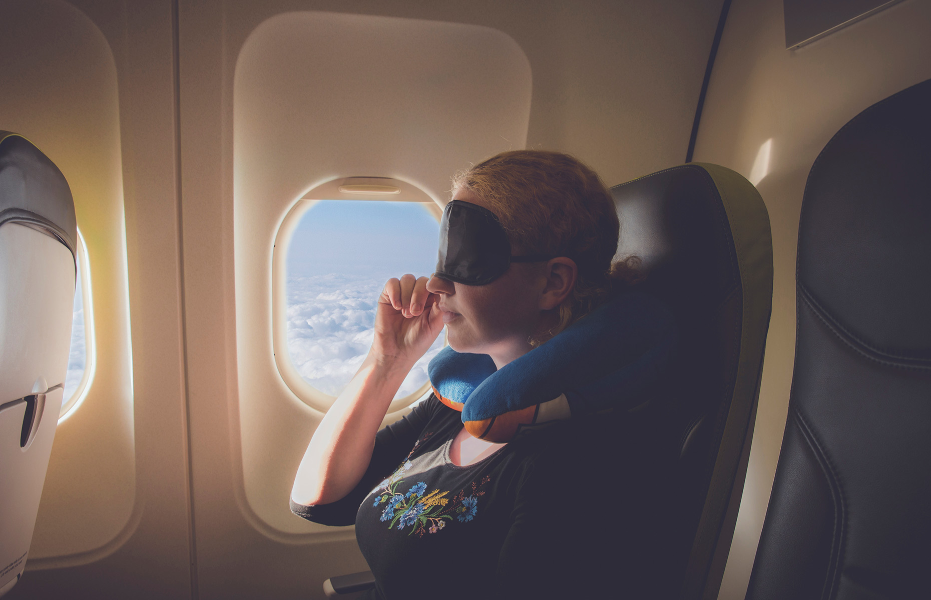 Sleeping on a plane (Image: FotoHelin/Shutterstock)