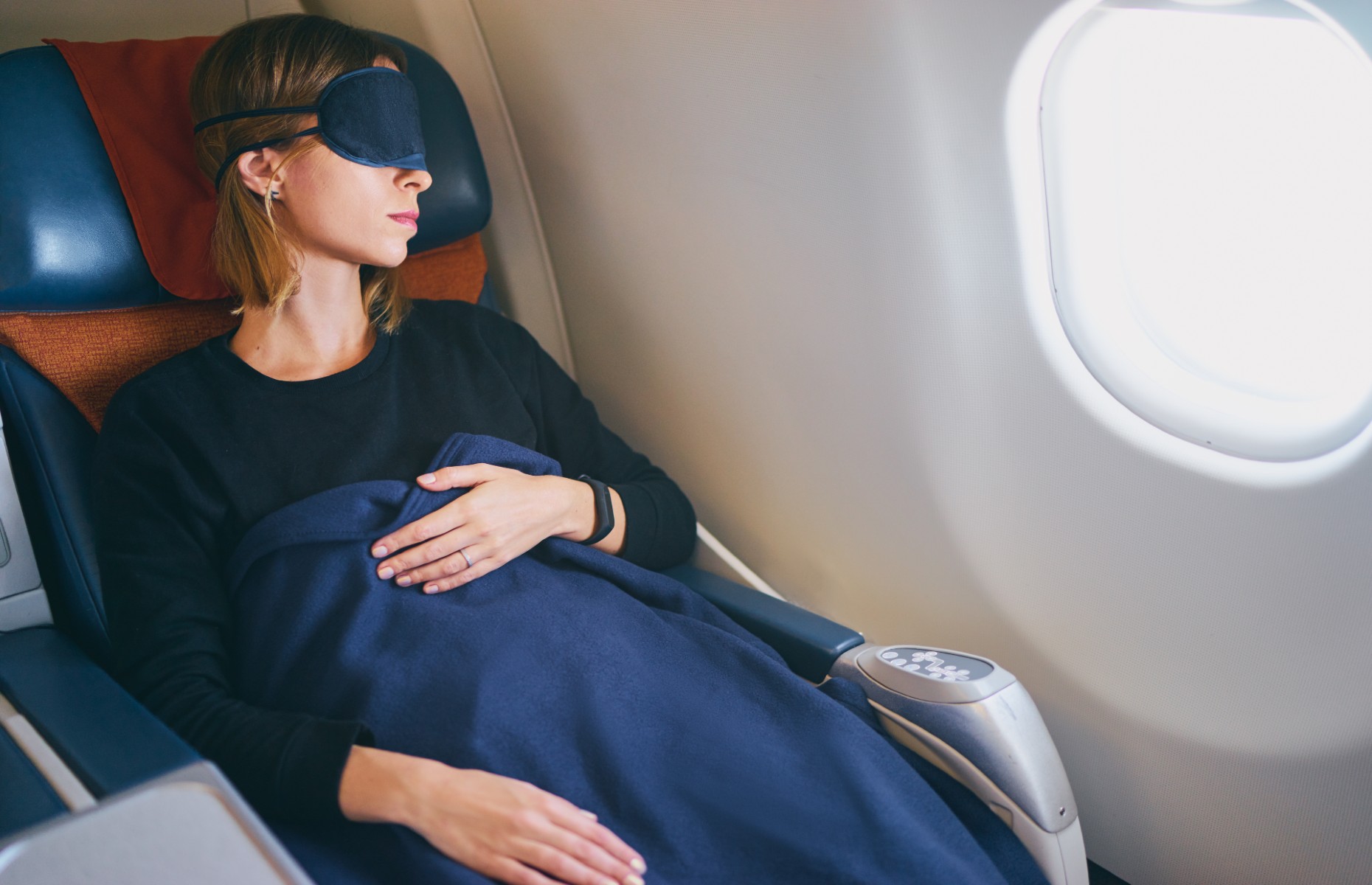 Passenger sleeping on a plane (Image: kudla/Shutterstock)