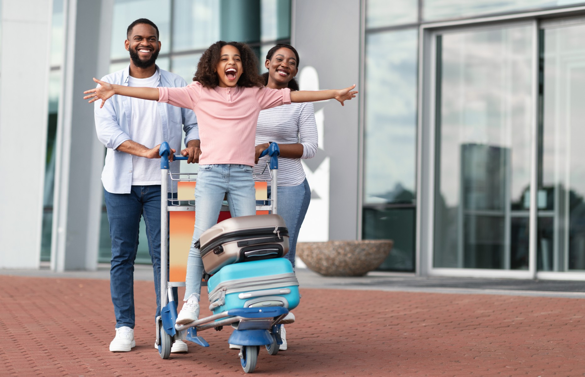 Excited passengers at the airport (Image: Prostock-studio/Shutterstock)