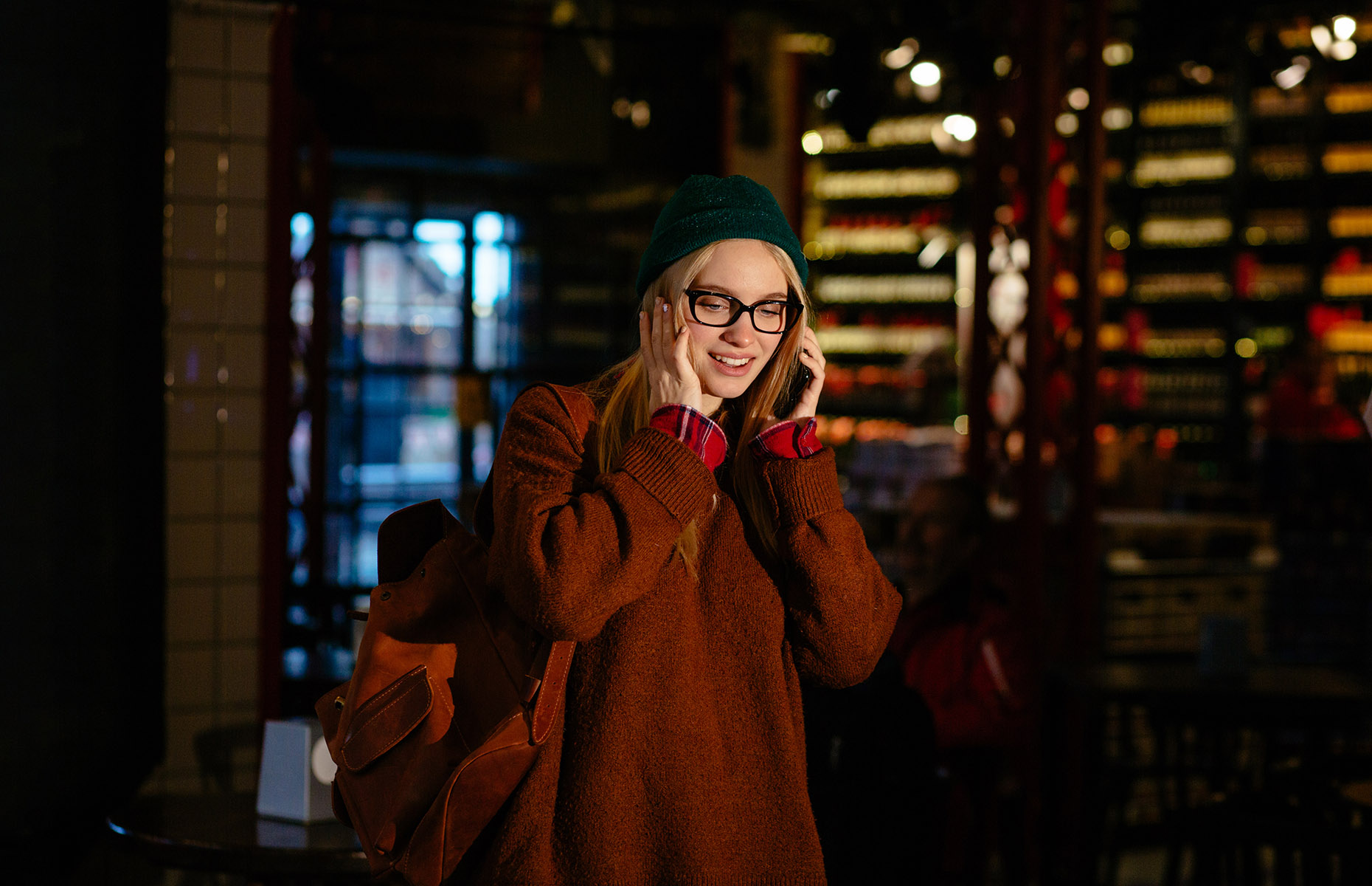 Girl on phone in a bar (Image: Iryna Inshyna/Shutterstock)