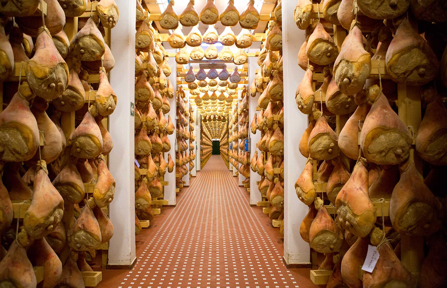 Hanging legs of Parma Ham (Image courtesy of Consorzio del Prosciutto di Parma)