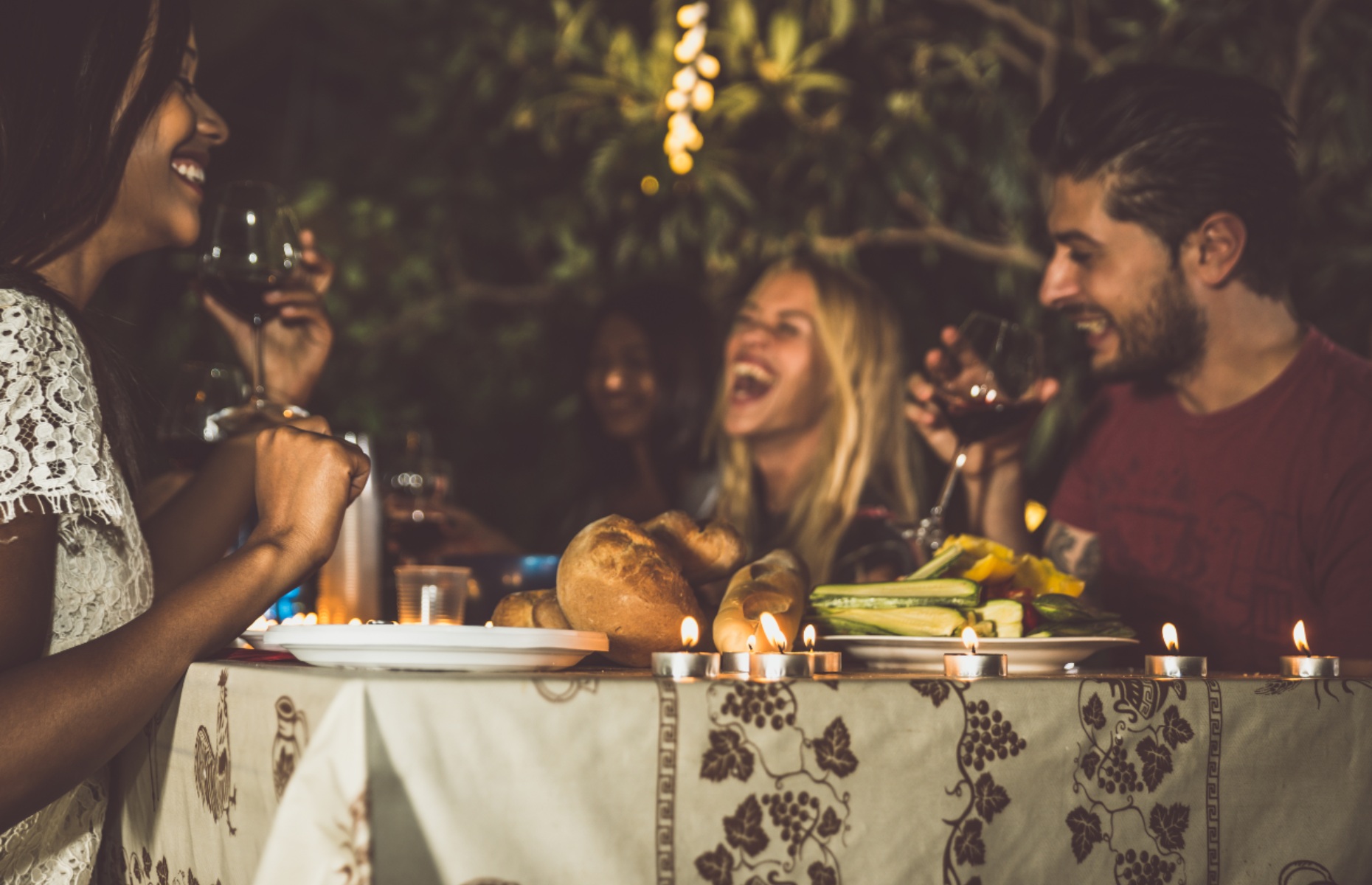 Friends having an evening meal together (Image: Oneinchepunch/Shutterstock)