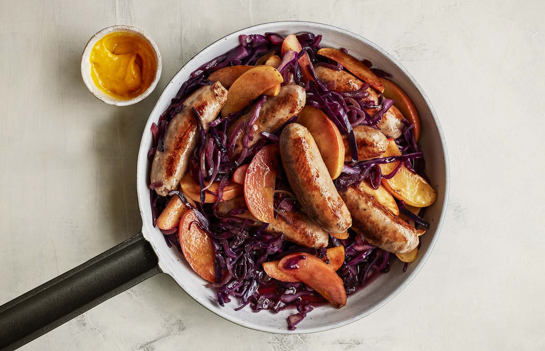 Quick braised red cabbage, sausages and apples (Image: Waitrose & Partners/loveFOOD)