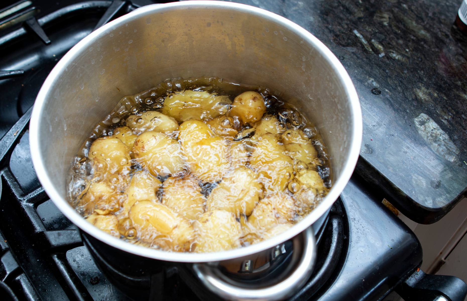Jersey royals cooking in simmering water [image: Clash and Clash/Shutterstock]