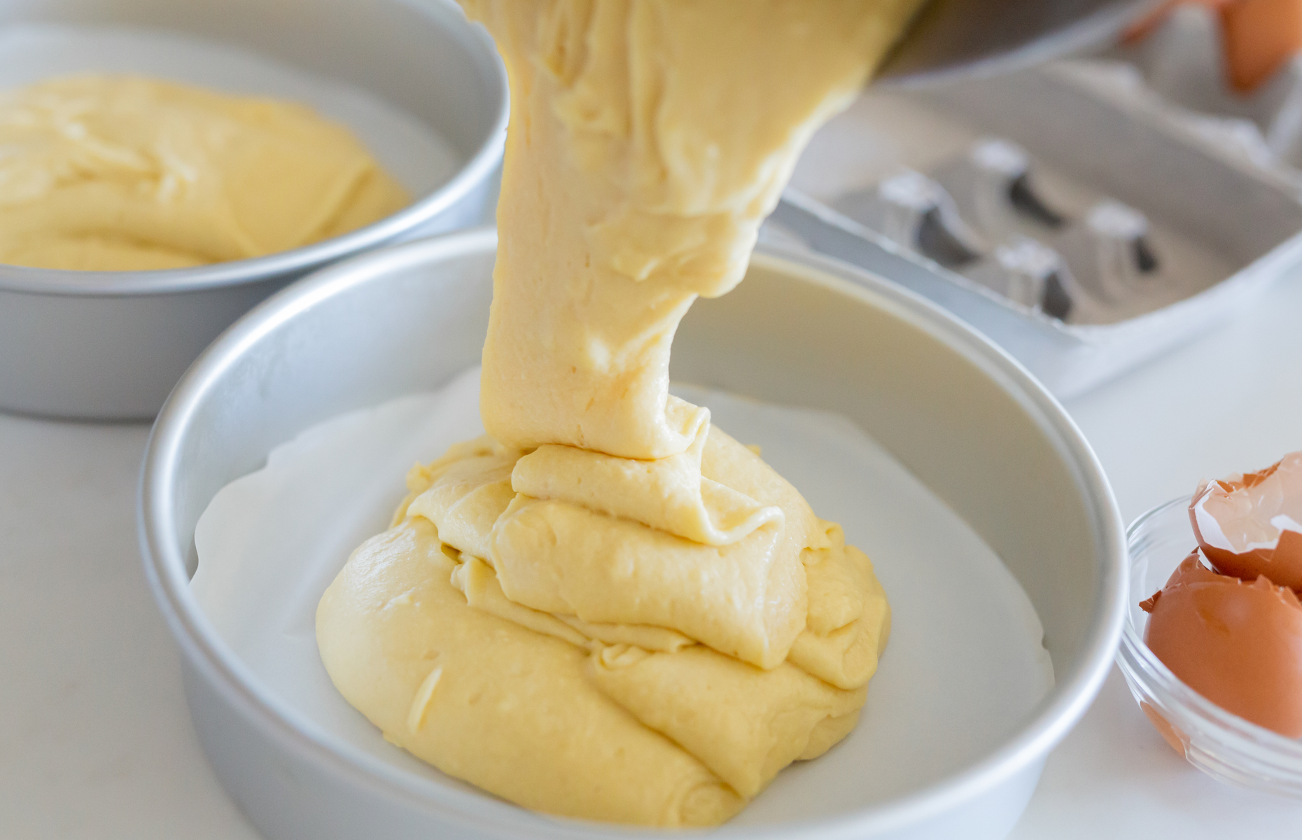 Pouring cake batter into a tin (Image: Karen Culp/Shutterstock)