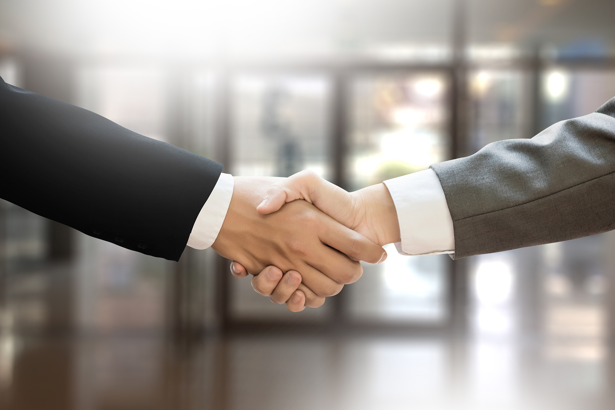 Two men shaking hands. (Image: Shutterstock)