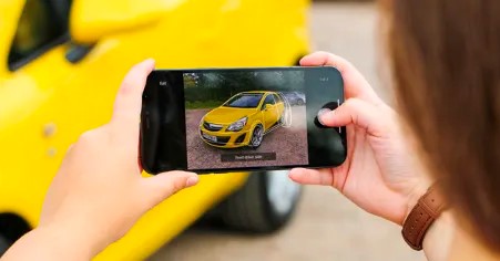 Woman taking a photo of a car (Image: motorway)