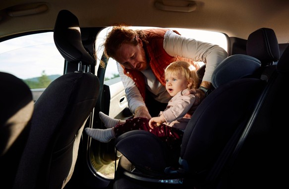 Man putting child in car (Image: Motorway)