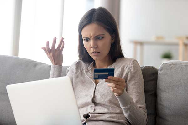 Upset woman looking at a computer. (Image: Shutterstock)