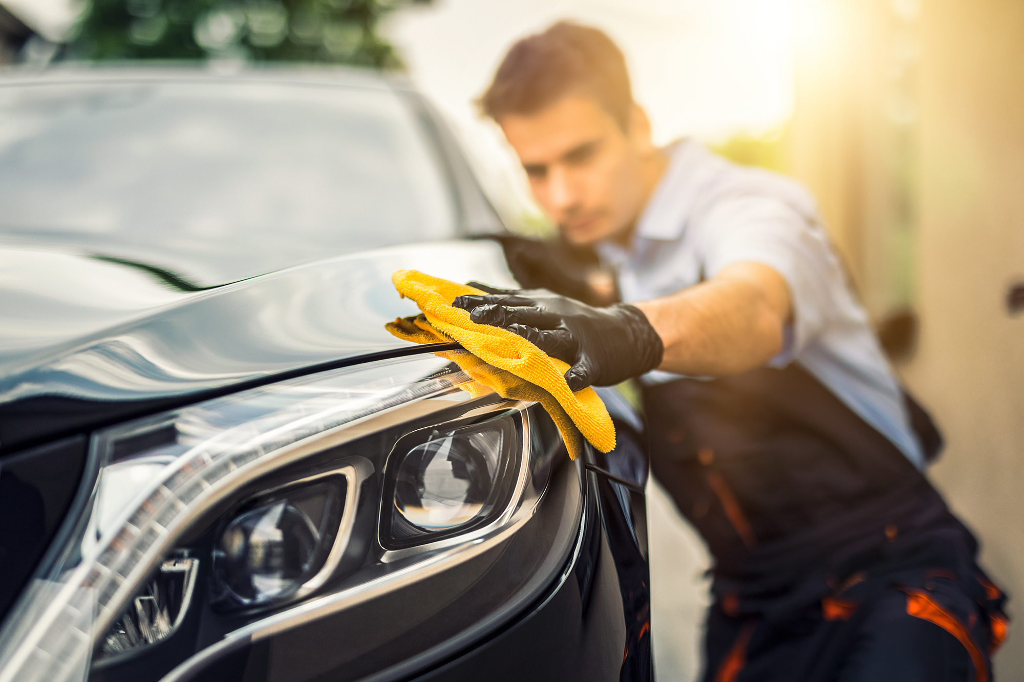 Man cleaning car. (Image: Shutterstock)