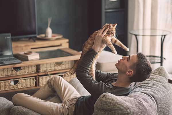 Man holding new cat. (Image: Shutterstock)