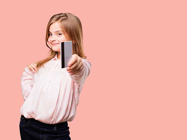 Child with a bank card. (Image: Shutterstock)