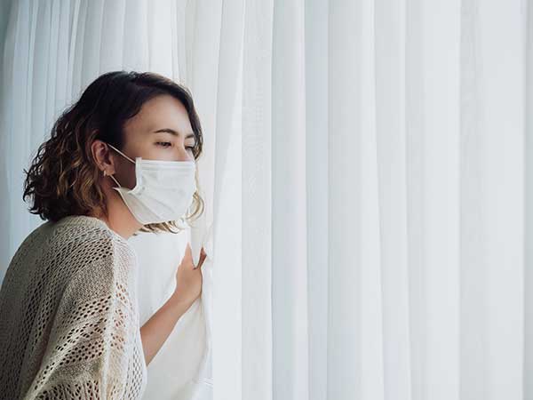 A woman self-isolating at home. (Image: Shutterstock)