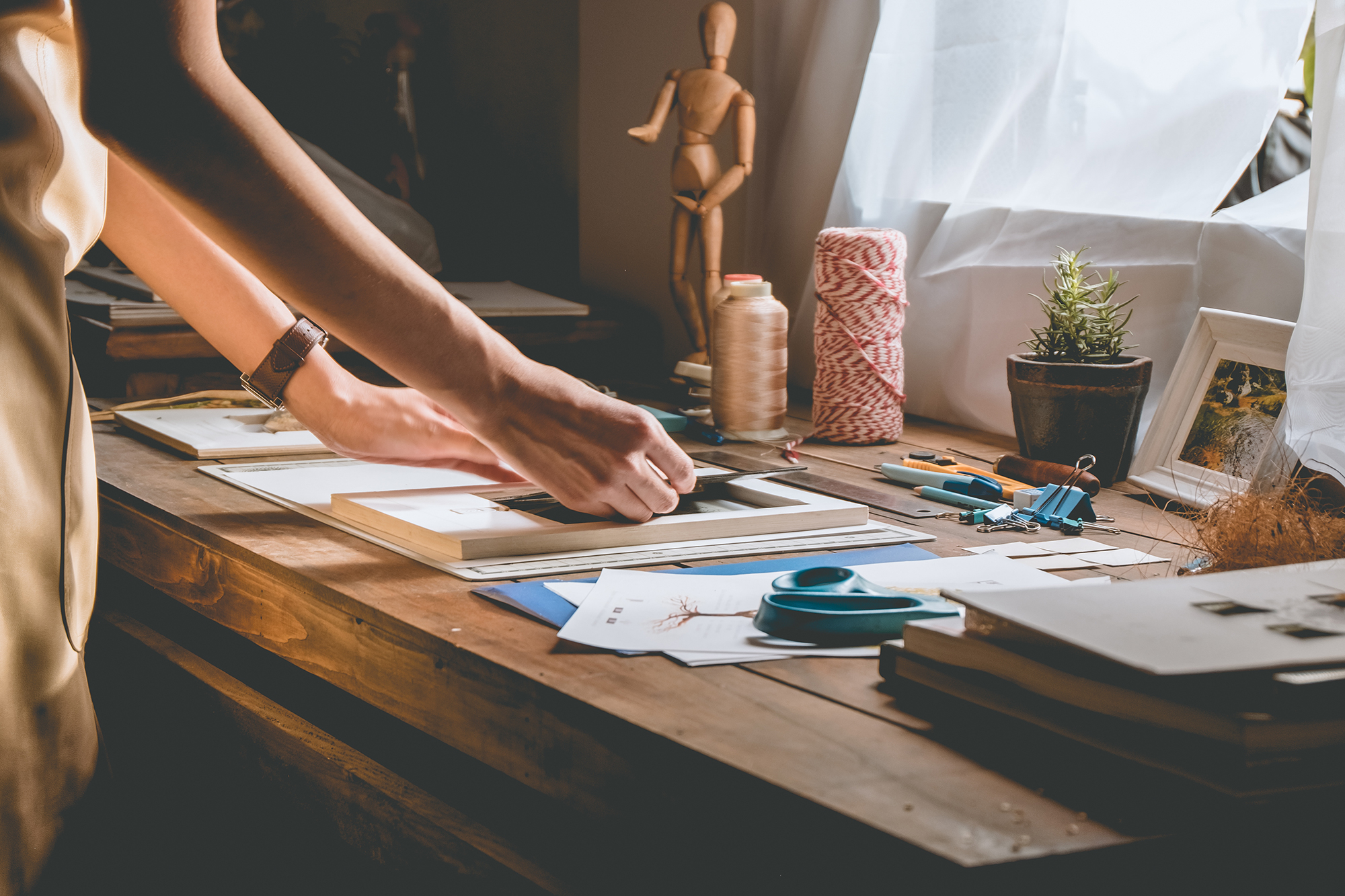 Woman making something with craft supplies. (Image: Shutterstock)