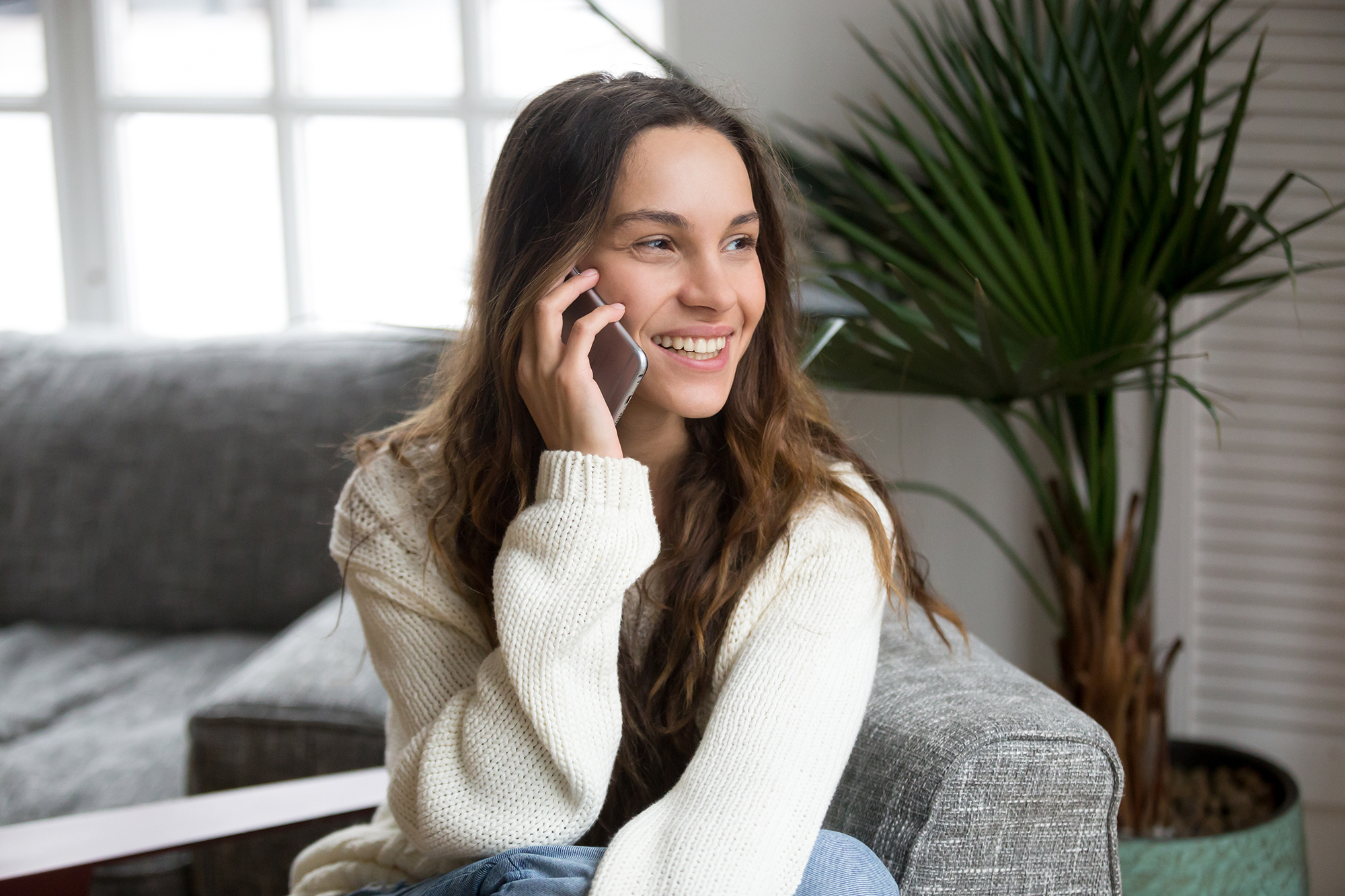 Happy woman on the phone. (Image: Shutterstock)