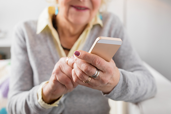 Elderly woman using a phone. (Image: Shutterstock)