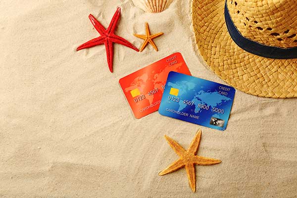 Credit cards on the beach. (Image: Shutterstock)