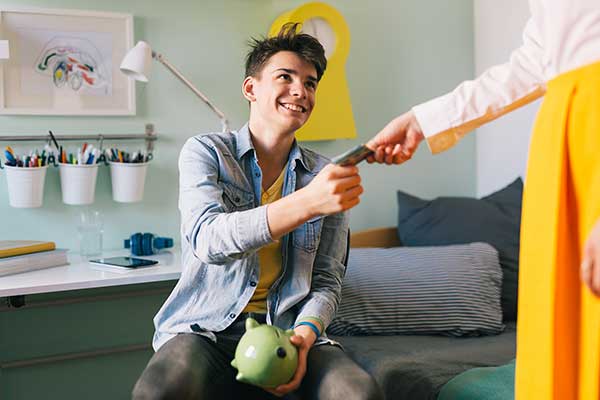 Teenager receiving pocket money. (Image: Shutterstock)