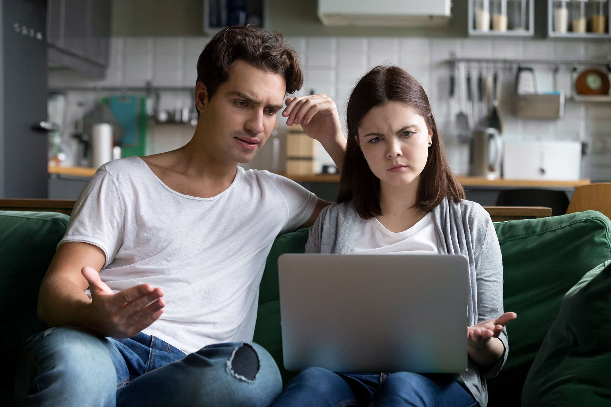 Annoyed couple looking at email. (Image: Shutterstock)