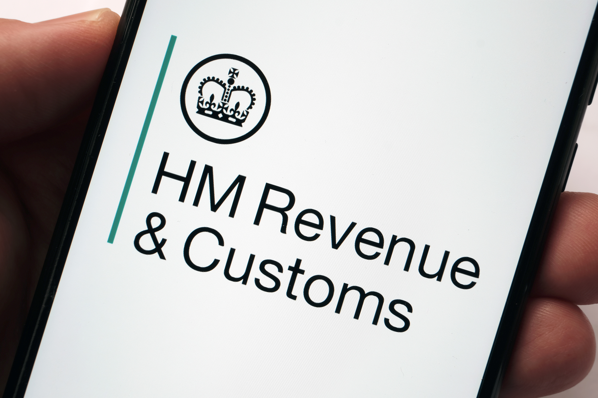 HMRC logo on mobile. (Image Shutterstock/Ascannio)