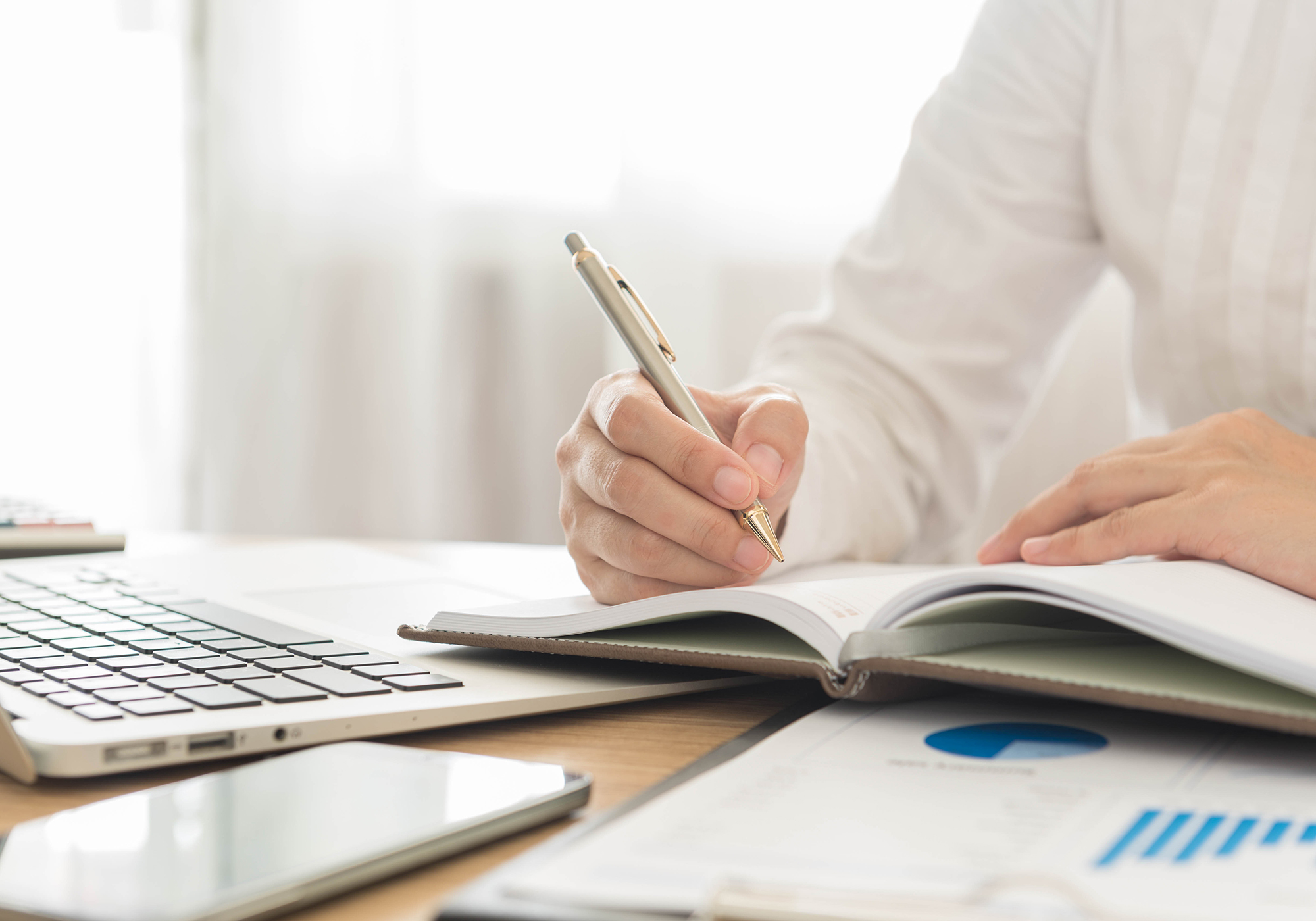 Man writing down investment plan. (Image: Shutterstock)