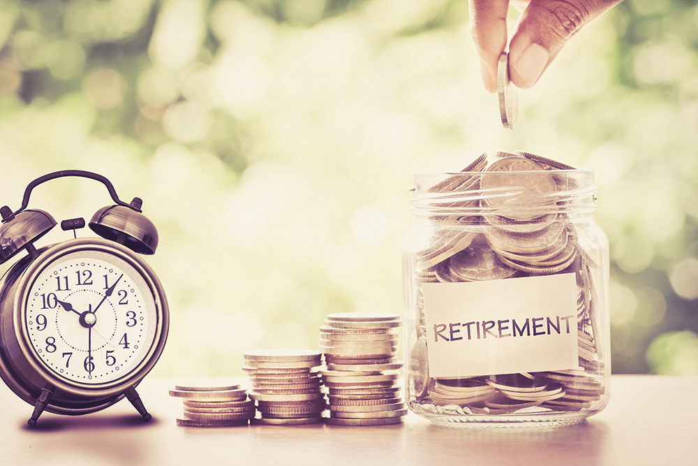 A pot for retirement filled with coins next to a clock. (Image: Shutterstock)