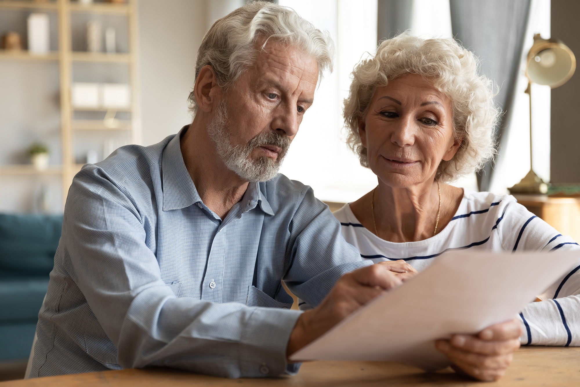 Older couple checking pension statement. (Image: Shutterstock)