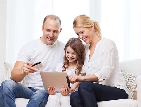 A family using a tablet. (Image: Shutterstock)