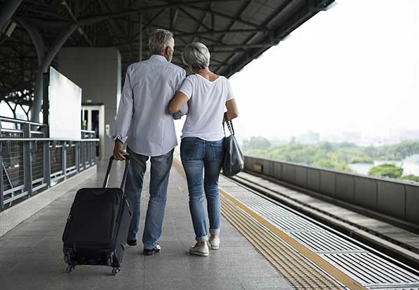 Senior people on a railway station platform. (Image: Shutterstock)