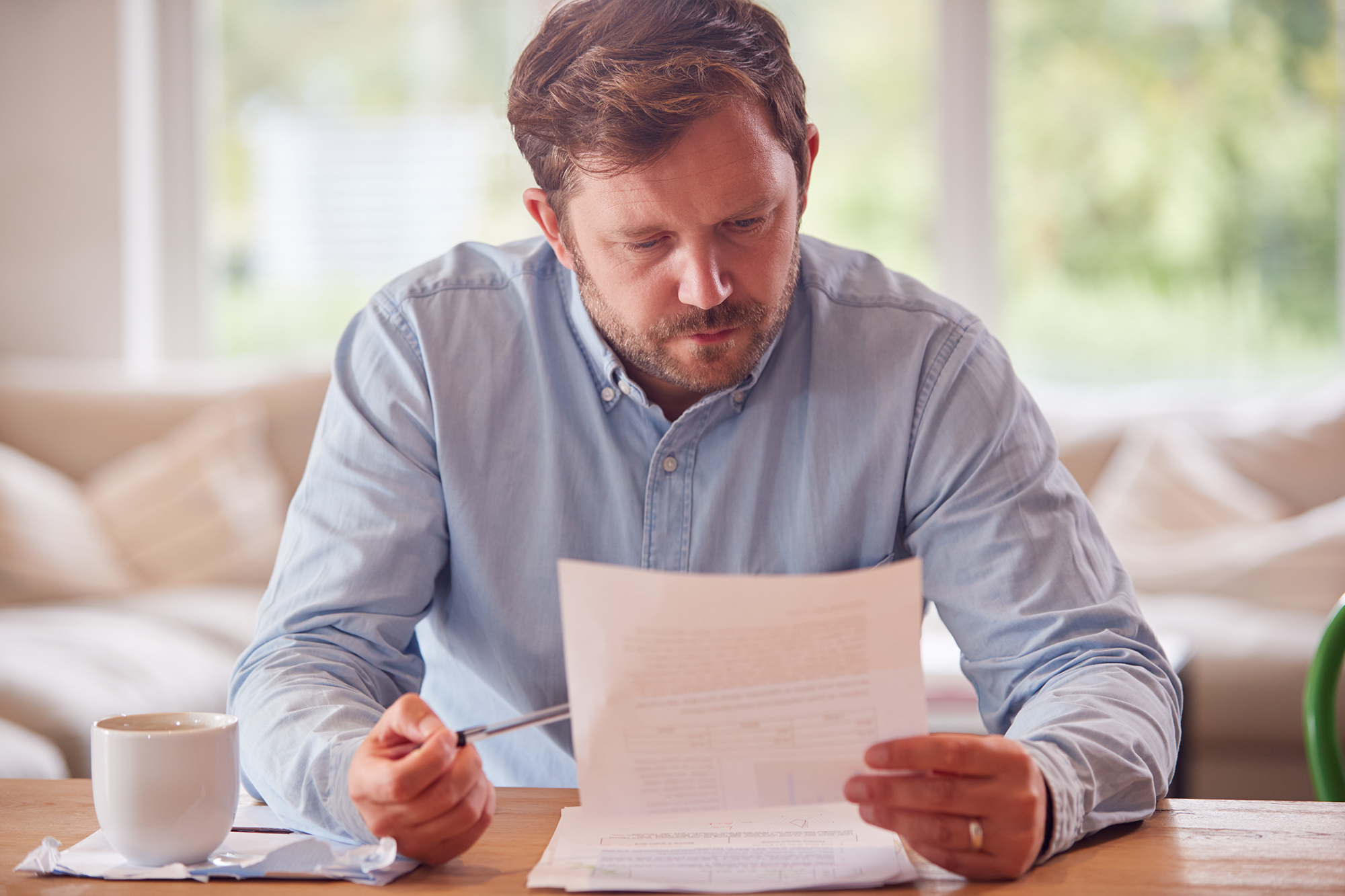 Man reading a document. (Image: Shutterstock)