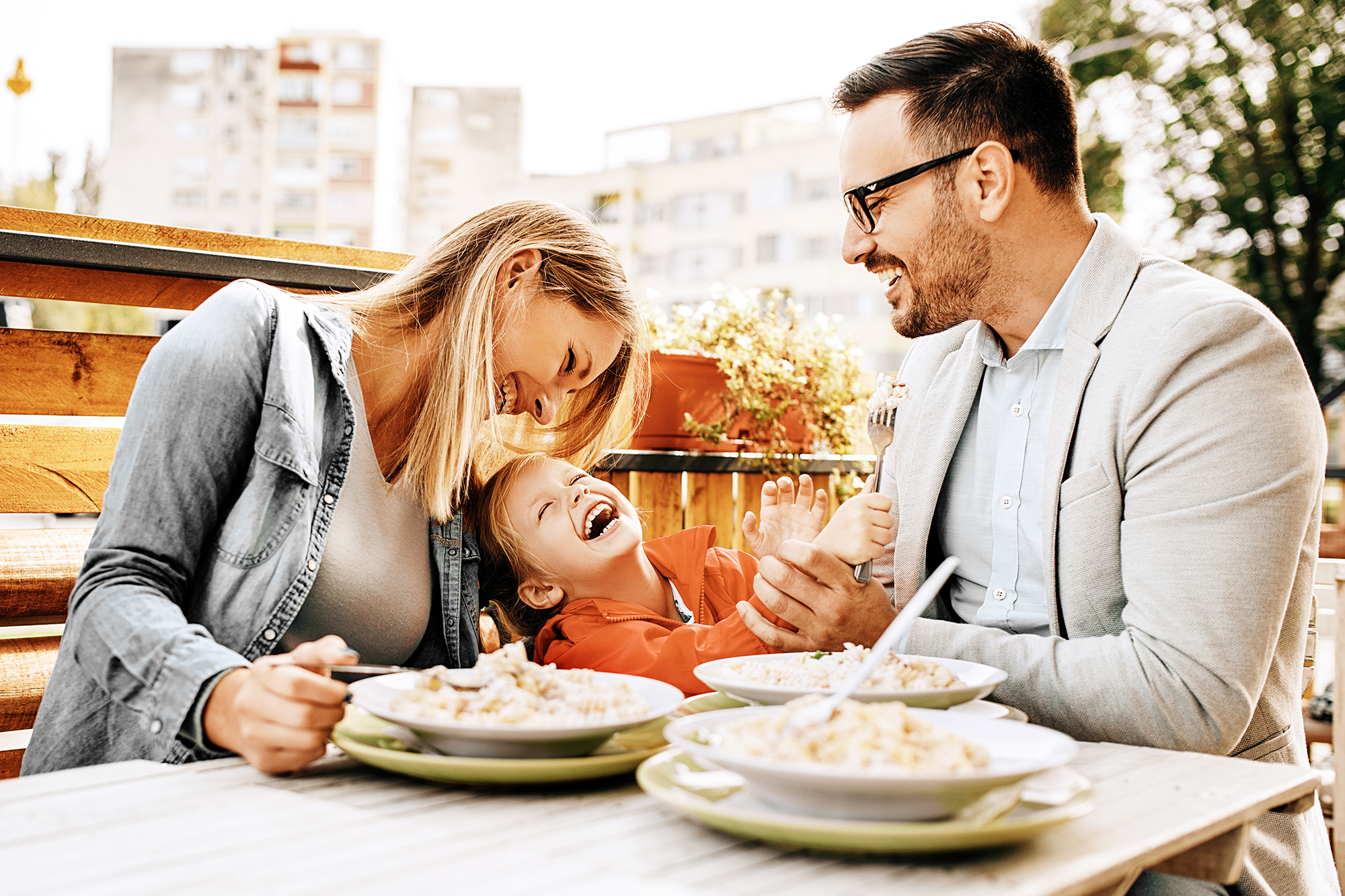 Happy family eating at a restaurant. (Image: Shutterstock)