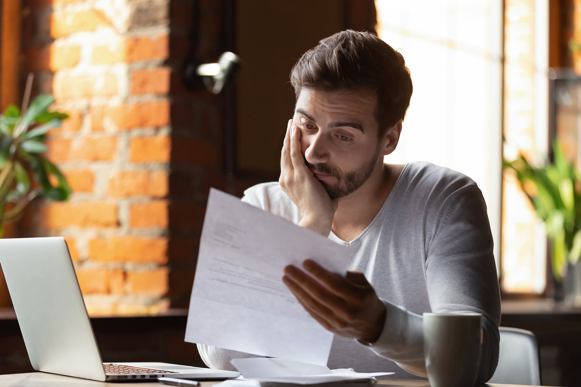 Disappointed man with a letter. (Image: Shutterstock)