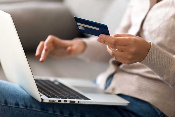 Woman using bank card. (Image: Shutterstock)