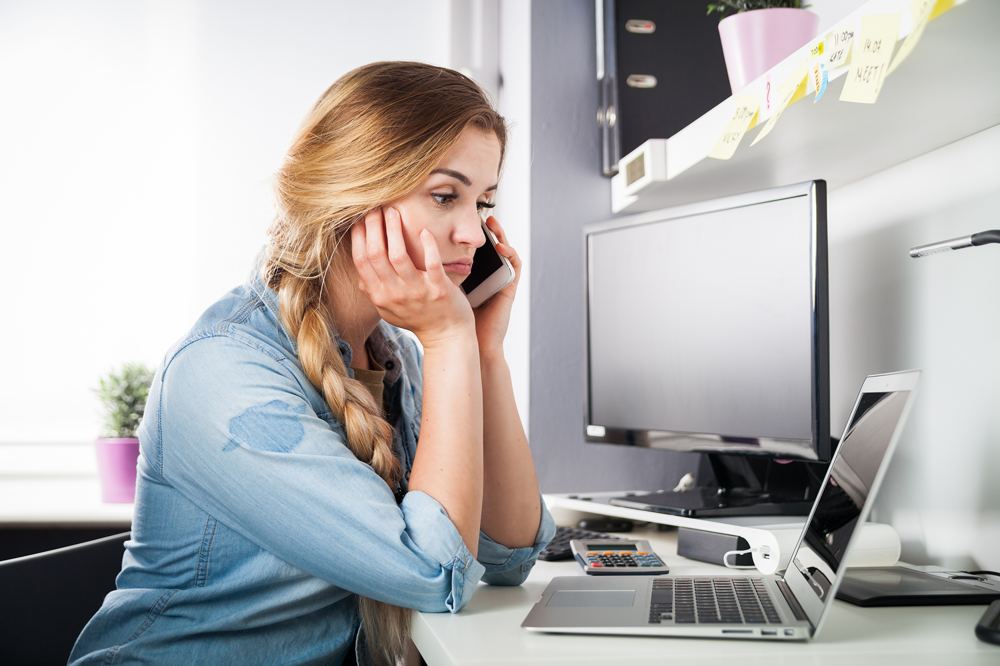 Confused woman on phone. (Image: Shutterstock)