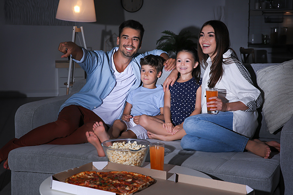 A family enjoying a film night at home. (Image: Shutterstock)